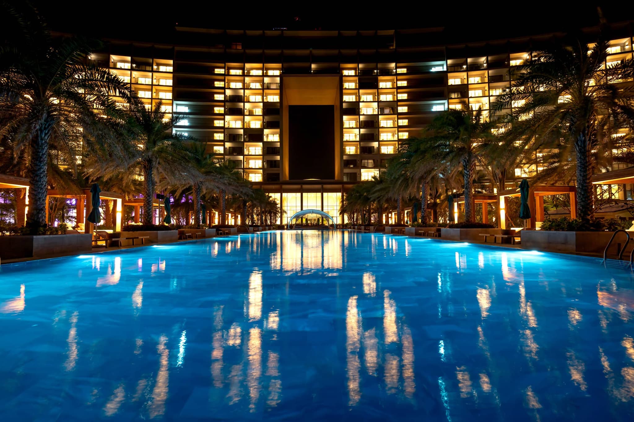 Resort hotel and pool illuminated at night
