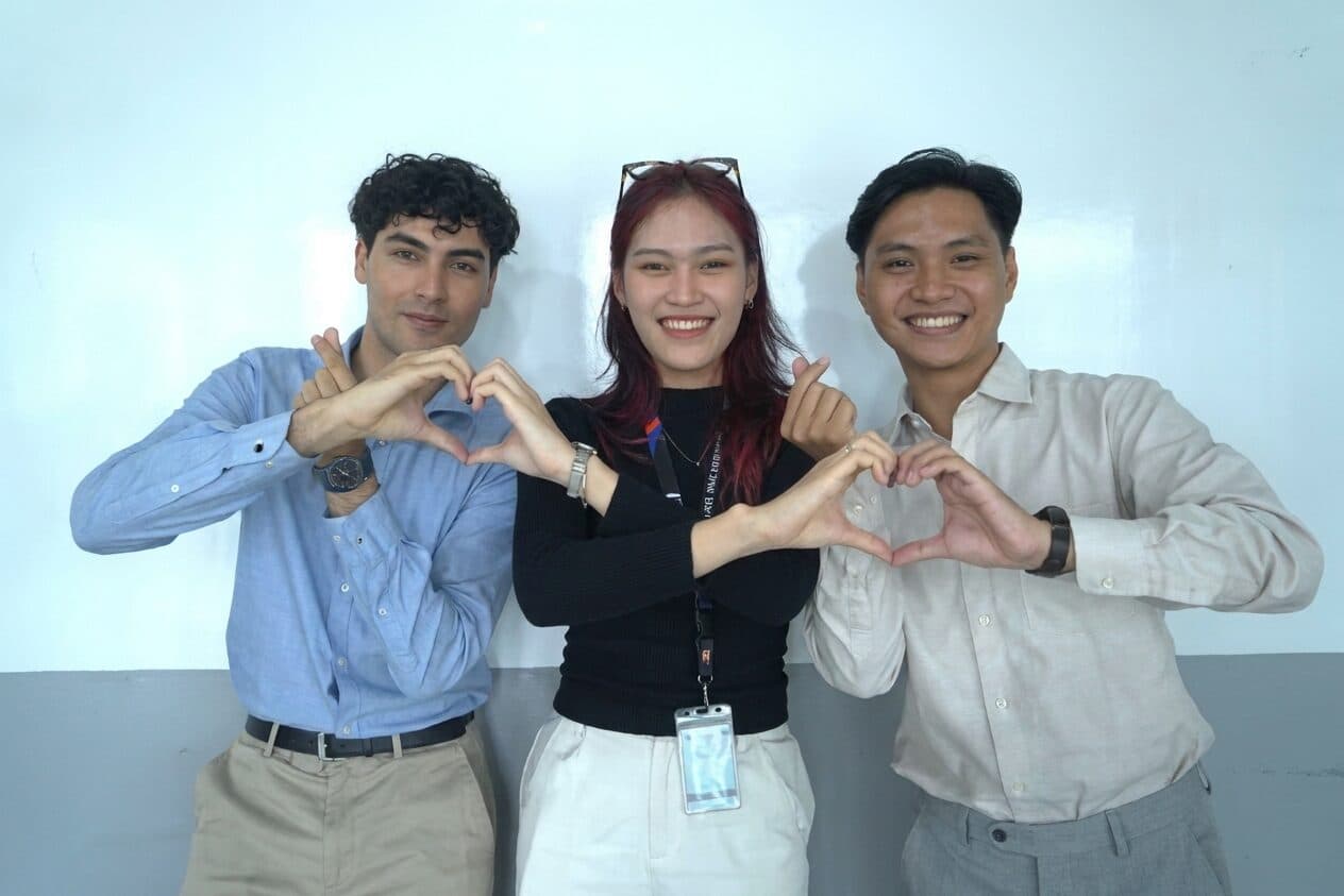 Three TRG interns making a heart shape with their hands
